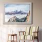 Impressionist alpine mountain landscape by John Singer Sargent in an ornate weathered white frame displayed in a light-toned interior setting.