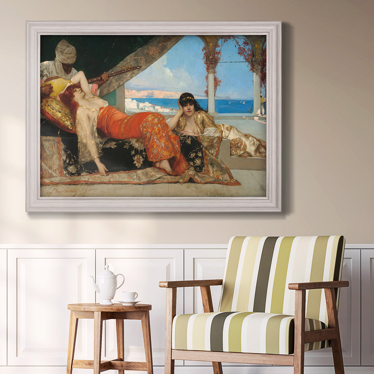 Orientalist portrait scene by Jean-Joseph Benjamin-Constant in an ornate weathered white frame displayed in a light-toned interior setting.