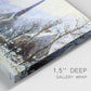 Close-up view of wrapped canvas corner featuring snow covered road leading to village.