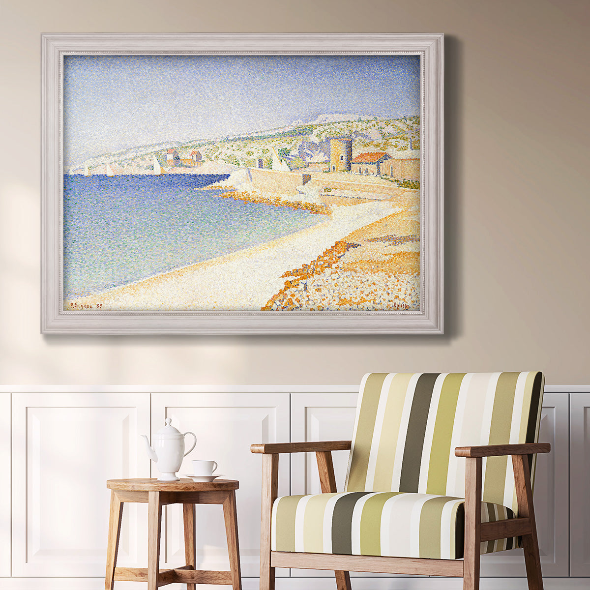 Impressionist Mediterranean jetty seascape by Paul Signac in an ornate weathered white frame displayed in a light-toned interior setting.