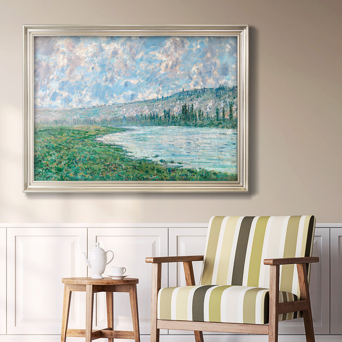 Impressionist river landscape at Vétheuil by Claude Monet in an ornate champagne frame displayed in a light-toned interior setting.