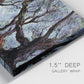 Close-up view of wrapped canvas corner featuring pine trees silhouetted at evening.