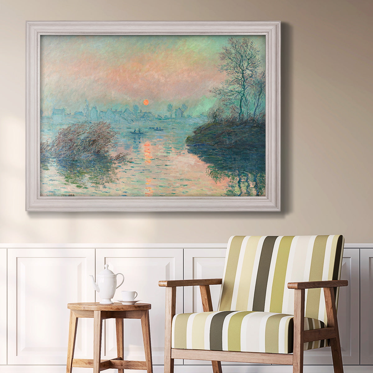 Impressionist winter river sunset scene by Claude Monet in an ornate weathered white frame displayed in a light-toned interior setting.