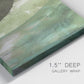 Close-up view of wrapped canvas corner featuring layered green abstract composition.