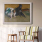 Impressionist portrait of a seated woman by Edgar Degas in an ornate weathered white frame displayed in a light-toned interior setting.