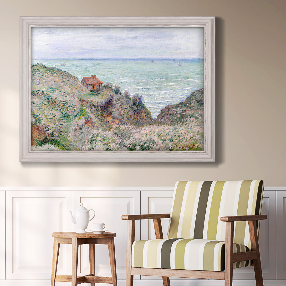 Impressionist coastal watch cabin scene by Claude Monet in an ornate weathered white frame displayed in a light-toned interior setting.