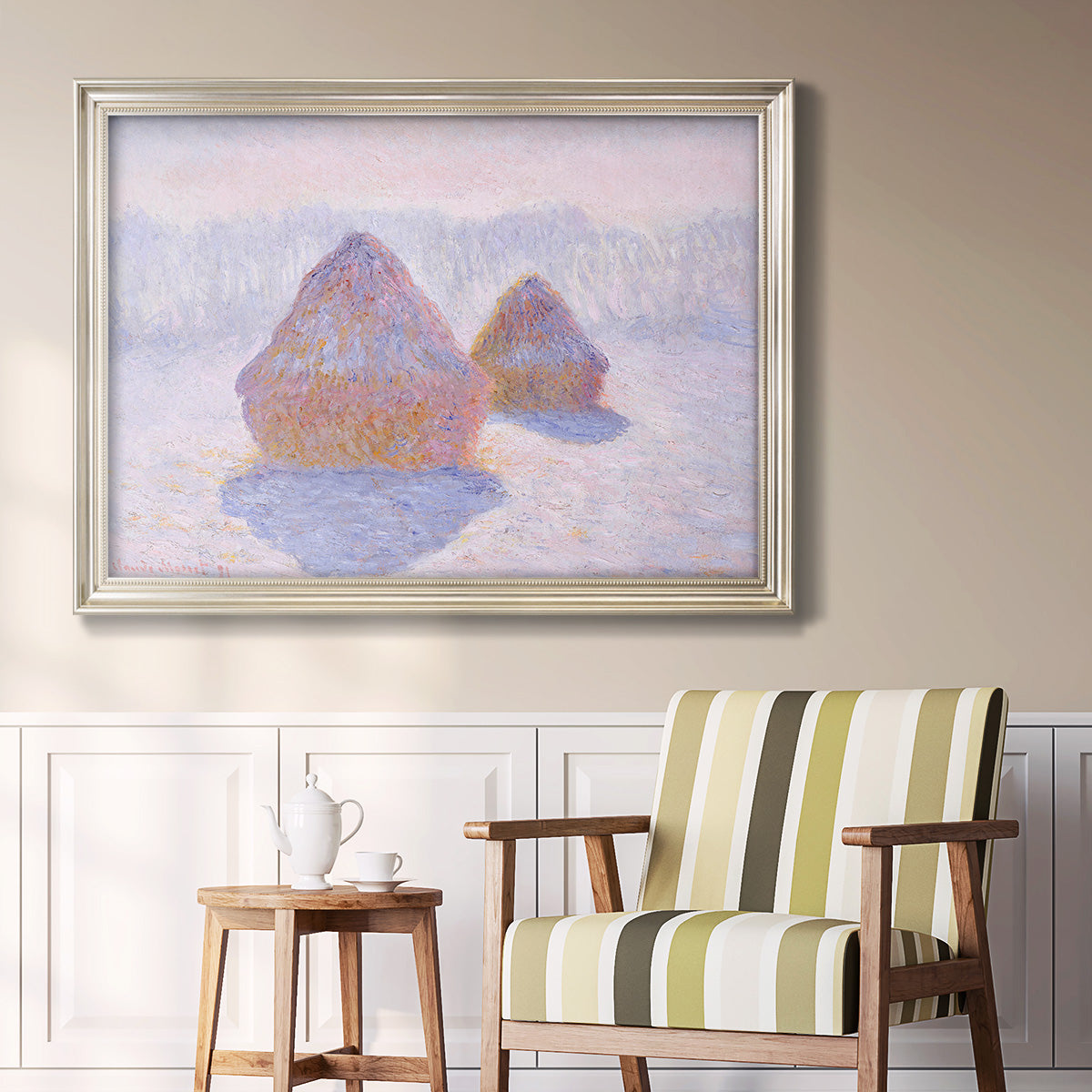 Impressionist winter haystack scene with sunlight by Claude Monet in an ornate champagne frame displayed in a light-toned interior setting.