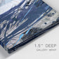 Close-up view of wrapped canvas corner featuring layered blue abstract texture.