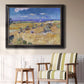 Impressionist wheat harvest scene by Vincent van Gogh in an ornate black frame with gilded inner detail displayed in a light-toned interior setting.