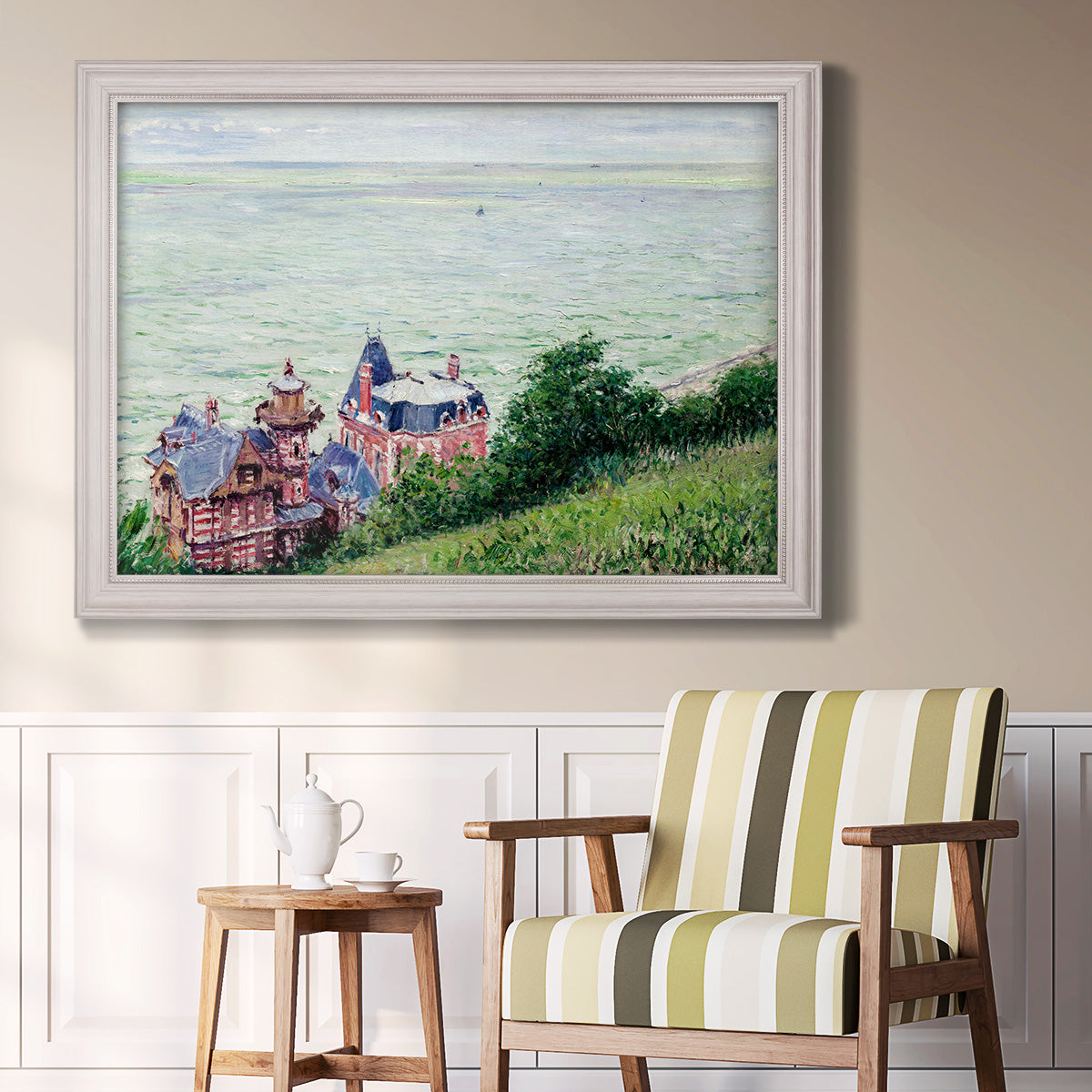 Impressionist coastal villas landscape by Gustave Caillebotte in an ornate weathered white frame displayed in a light-toned interior setting.