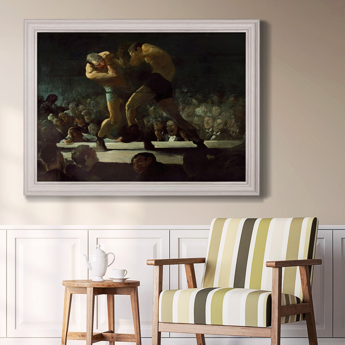 American social club scene painting by George Bellows in an ornate weathered white frame displayed in a light-toned interior setting.