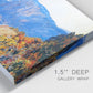 Close-up view of wrapped canvas corner featuring winding red road hillside.