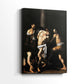 Side view of a canvas art print of a religious scene with muscular forms and dark background, showing gallery-wrapped depth.
