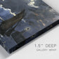 Close-up view of wrapped canvas corner featuring dark seascape under night sky.