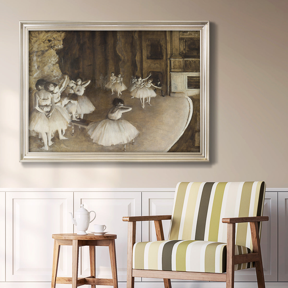 Impressionist ballet rehearsal scene by Edgar Degas in an ornate champagne frame displayed in a light-toned interior setting.