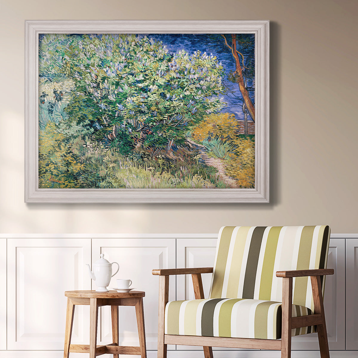 Impressionist lilac flower painting by Vincent van Gogh in an ornate weathered white frame displayed in a light-toned interior setting.