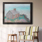Impressionist coastal building landscape by Claude Monet in an ornate black frame with gilded inner detail displayed in a light-toned interior setting.