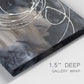 Close-up view of wrapped canvas corner featuring dark swirling abstract motion.