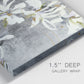 Close-up view of wrapped canvas corner featuring delicate floral symbolic arrangement.
