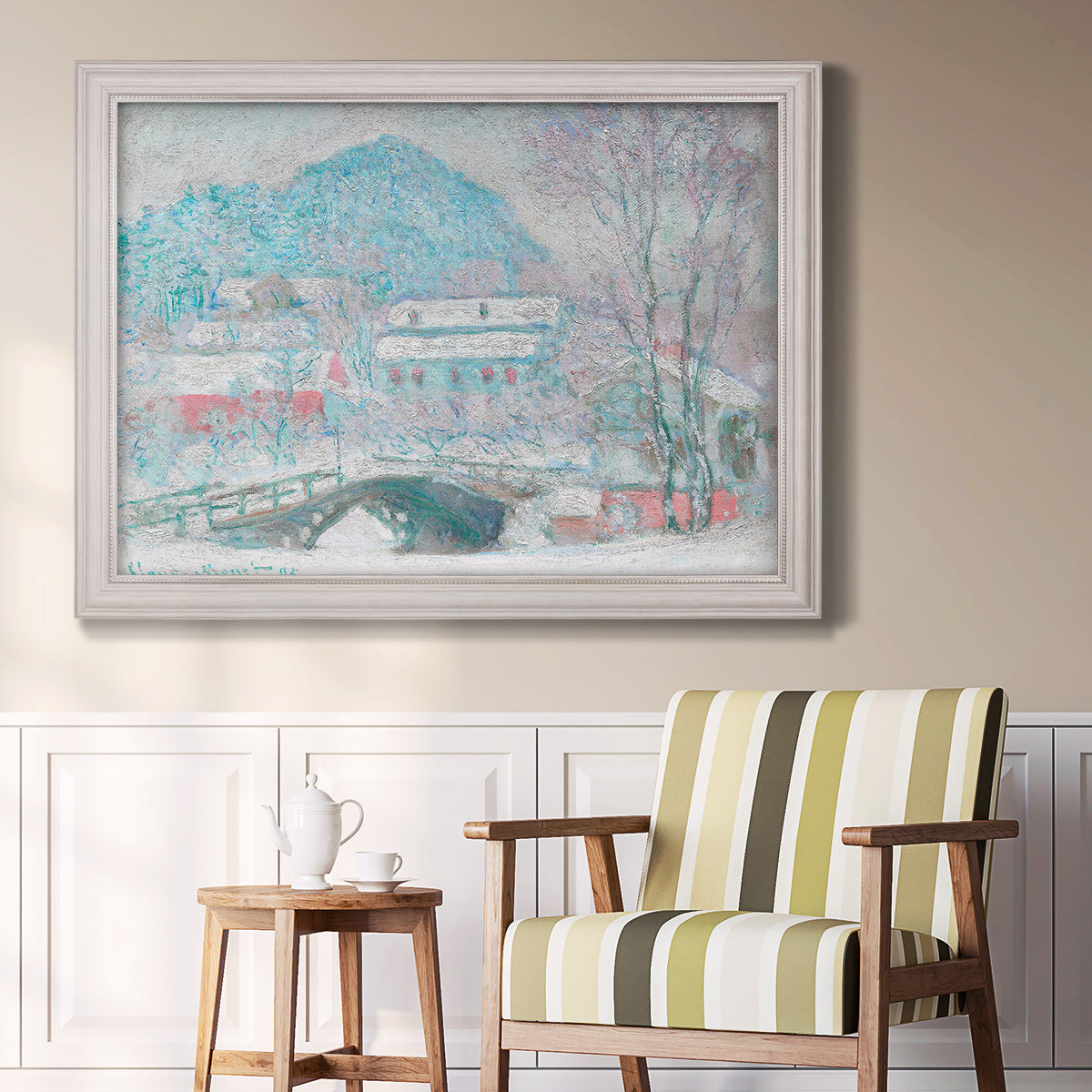 Impressionist coastal village landscape in Norway by Claude Monet in an ornate weathered white frame displayed in a light-toned interior setting.