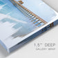 Close-up view of wrapped canvas corner featuring coastal pier extending over water.