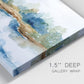 Close-up view of wrapped canvas corner featuring abstract blue watercolor landscape.