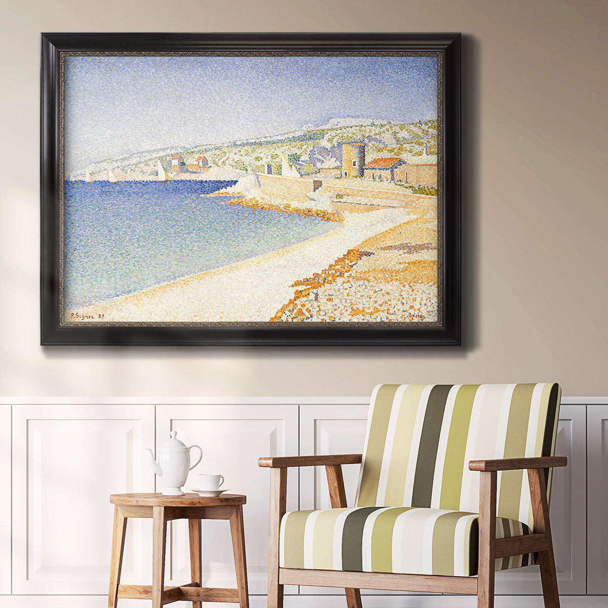 Impressionist Mediterranean jetty seascape by Paul Signac in an ornate black frame with gilded inner detail displayed in a light-toned interior setting.