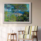 Impressionist Mediterranean coastal landscape by Claude Monet in an ornate weathered white frame displayed in a light-toned interior setting.