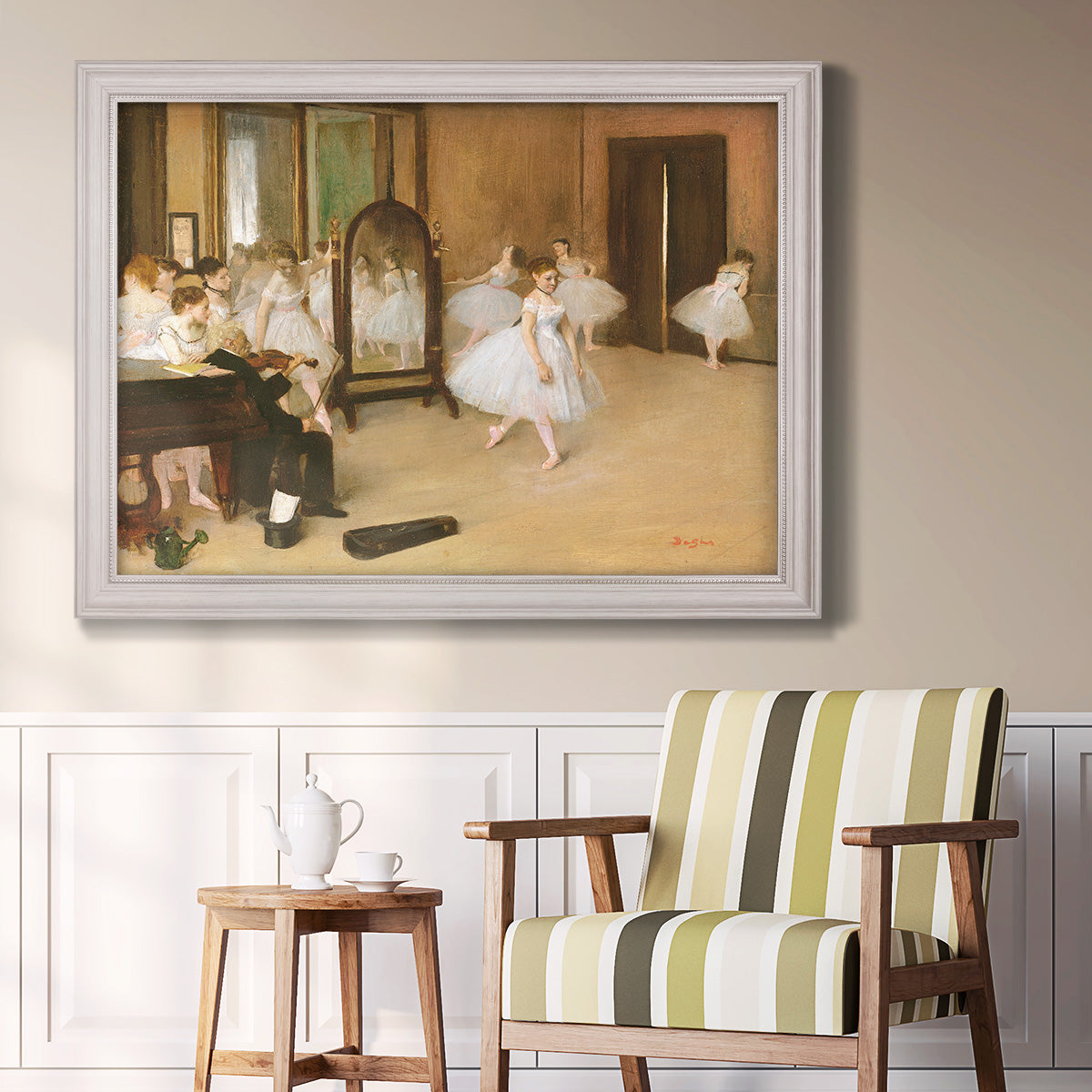 Impressionist dance class interior scene by Edgar Degas in an ornate weathered white frame displayed in a light-toned interior setting.