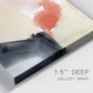 Close-up view of wrapped canvas corner featuring playful abstract watercolor shapes.