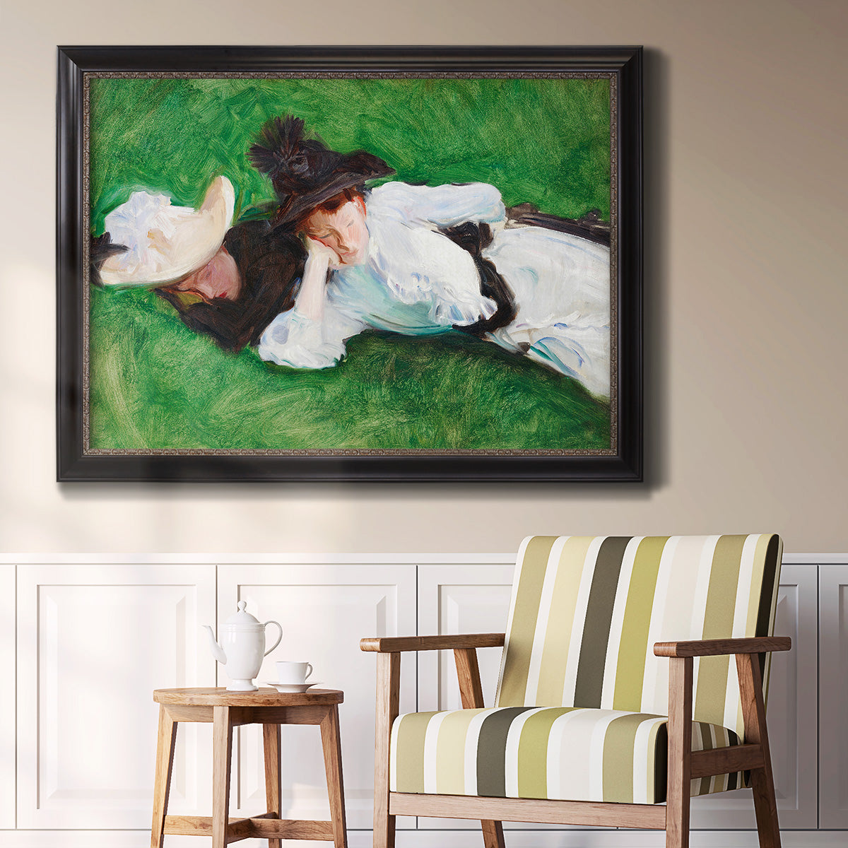 Impressionist outdoor portrait of two girls by John Singer Sargent in an ornate black frame with gilded inner detail displayed in a light-toned interior setting.