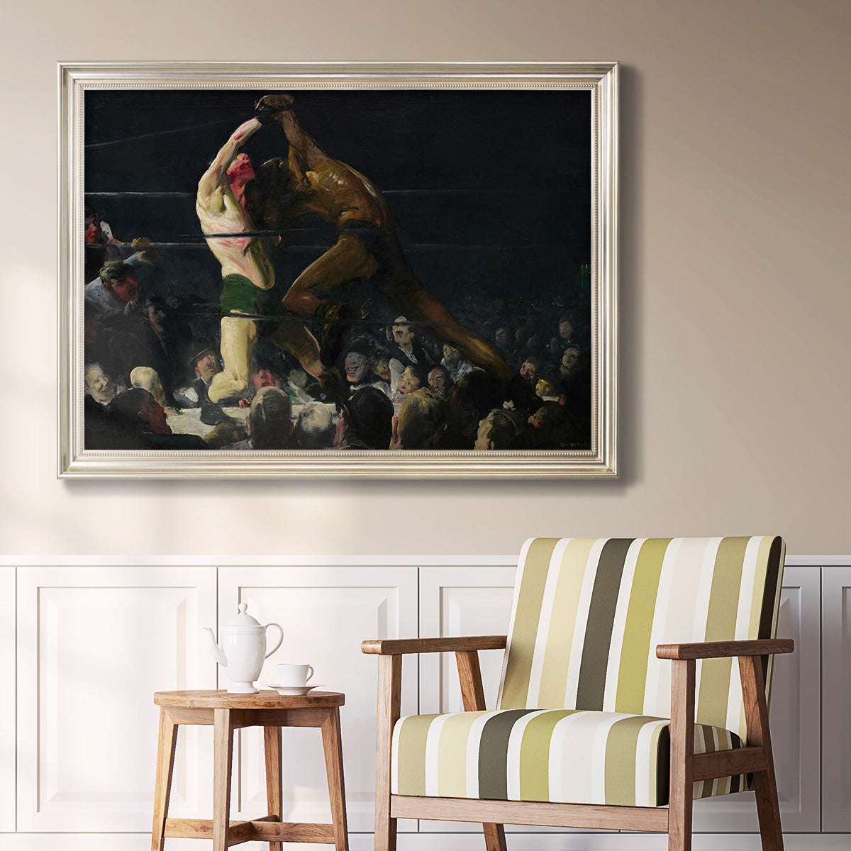 American genre painting of men in a social club by George Bellows in an ornate champagne frame displayed in a light-toned interior setting.