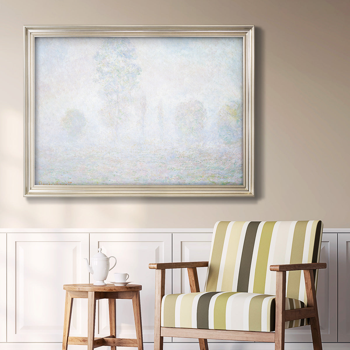 Impressionist atmospheric landscape in morning haze by Claude Monet in an ornate champagne frame displayed in a light-toned interior setting.