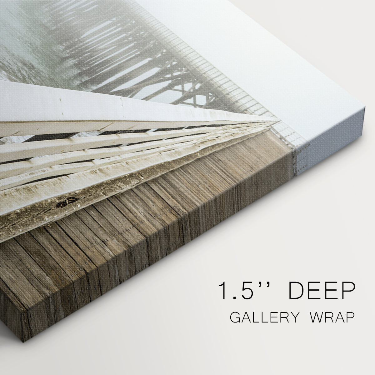 Fog envelops a pier while waves gently lap against the shore on a tranquil morning