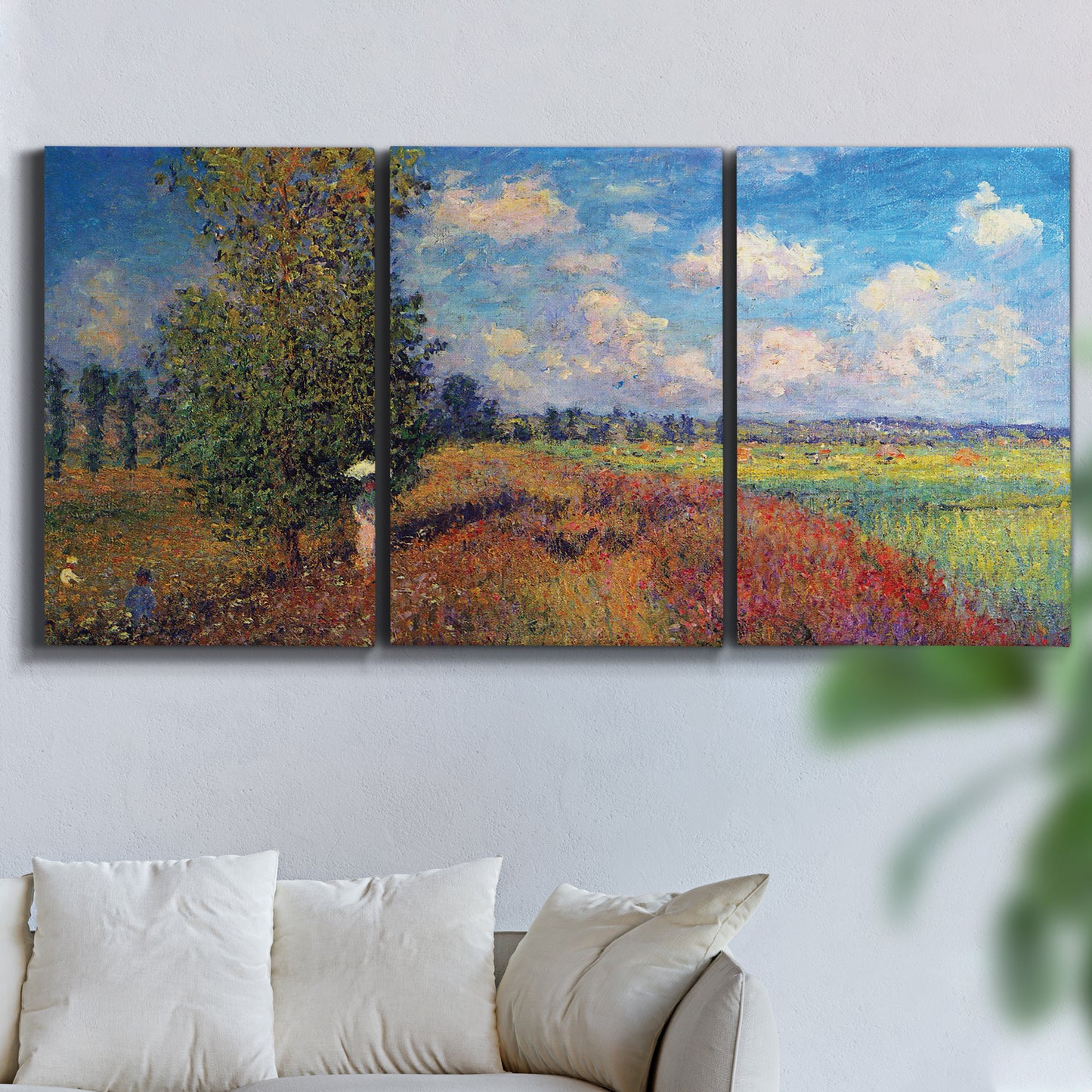 Three-panel canvas wall art featuring summer poppy field in bloom, displayed in a living room above a sofa.