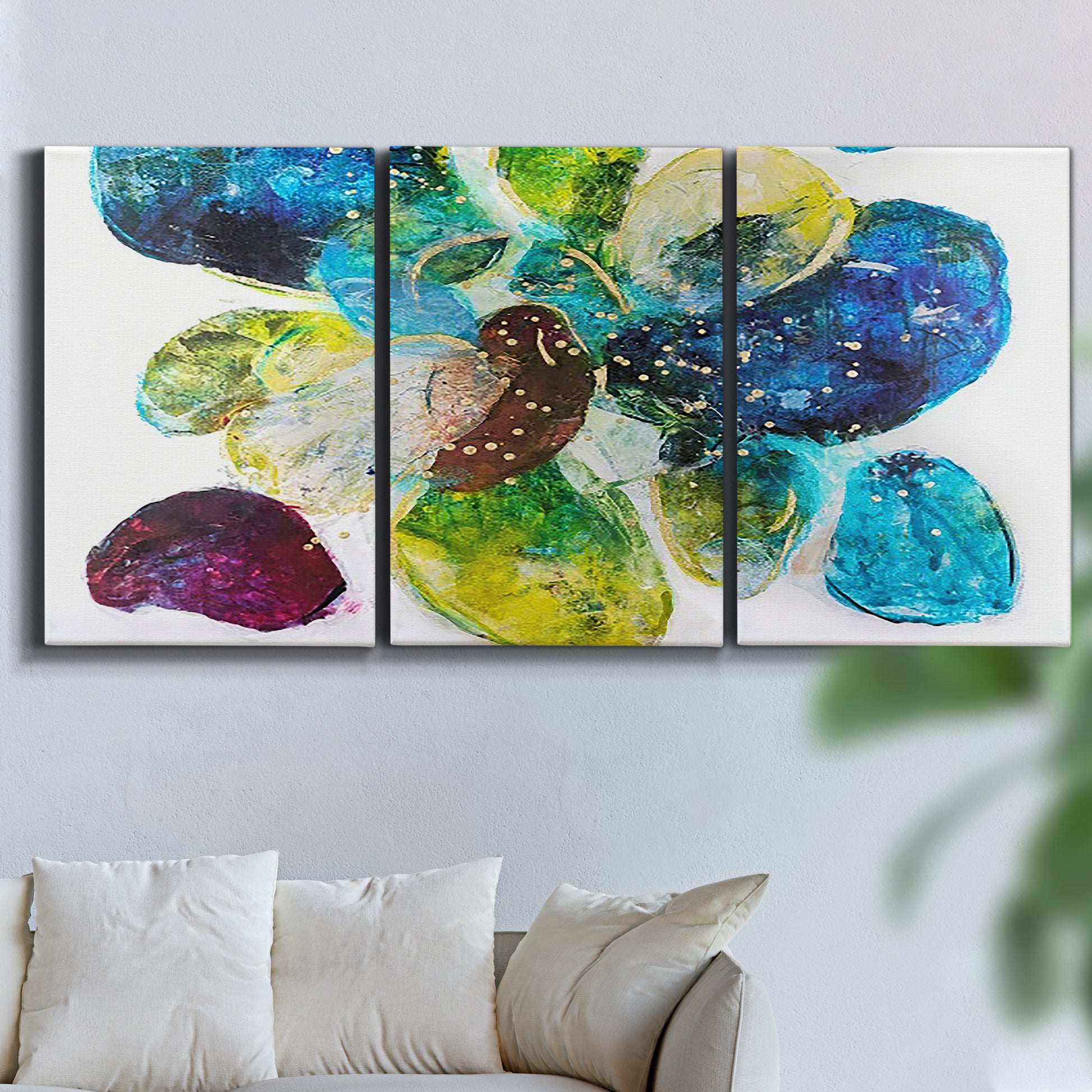 Three-panel canvas wall art featuring expressive abstract color interpretations, displayed in a living room above a sofa.