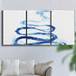 Three-panel canvas wall art featuring indigo abstract vapor watercolor, displayed in a living room above a sofa.