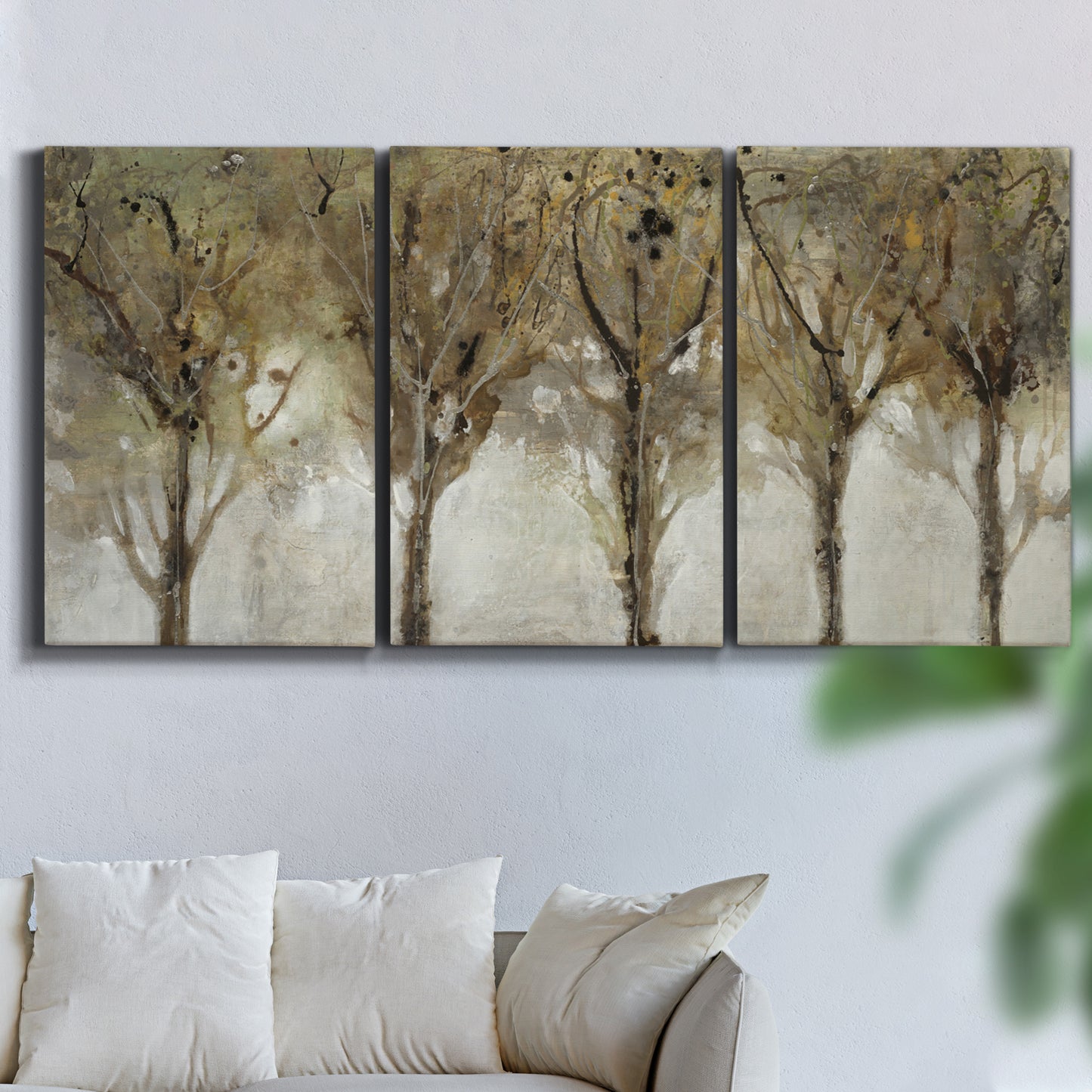 Three-panel canvas wall art featuring sunlight filtering through trees, displayed in a living room above a sofa.