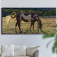 Three-panel canvas wall art featuring horses standing near farmhouse, displayed in a living room above a sofa.
