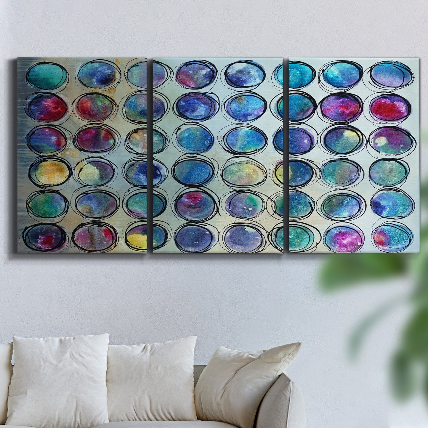 Three-panel canvas wall art featuring contrasting geometric abstract variations, displayed in a living room above a sofa.