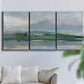 Three-panel canvas wall art featuring twilight landscape with fading light, displayed in a living room above a sofa.