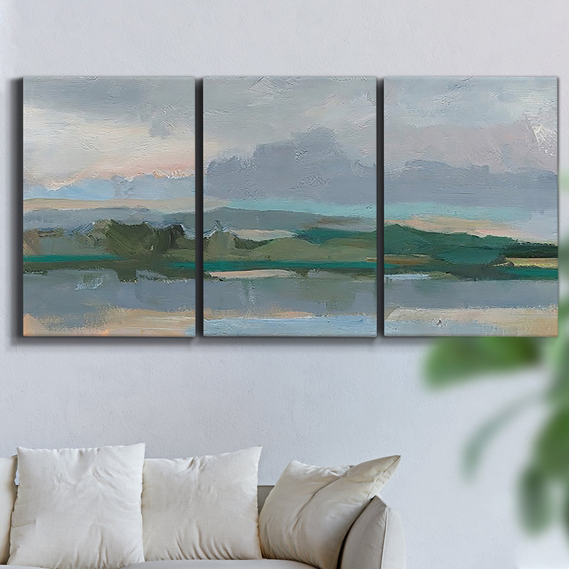 Three-panel canvas wall art featuring twilight landscape with fading light, displayed in a living room above a sofa.