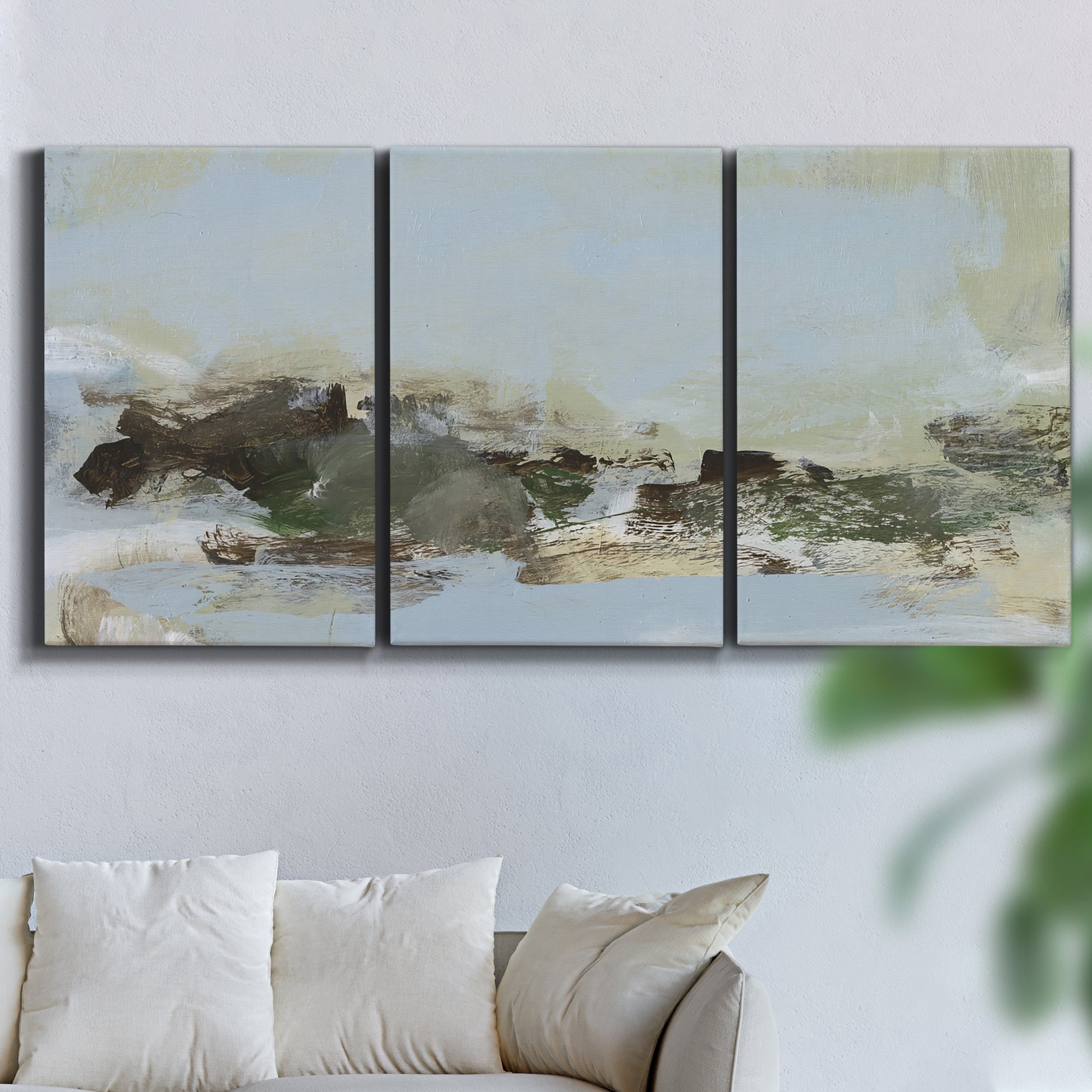 Three-panel canvas wall art featuring minimal abstract summer landscape, displayed in a living room above a sofa.