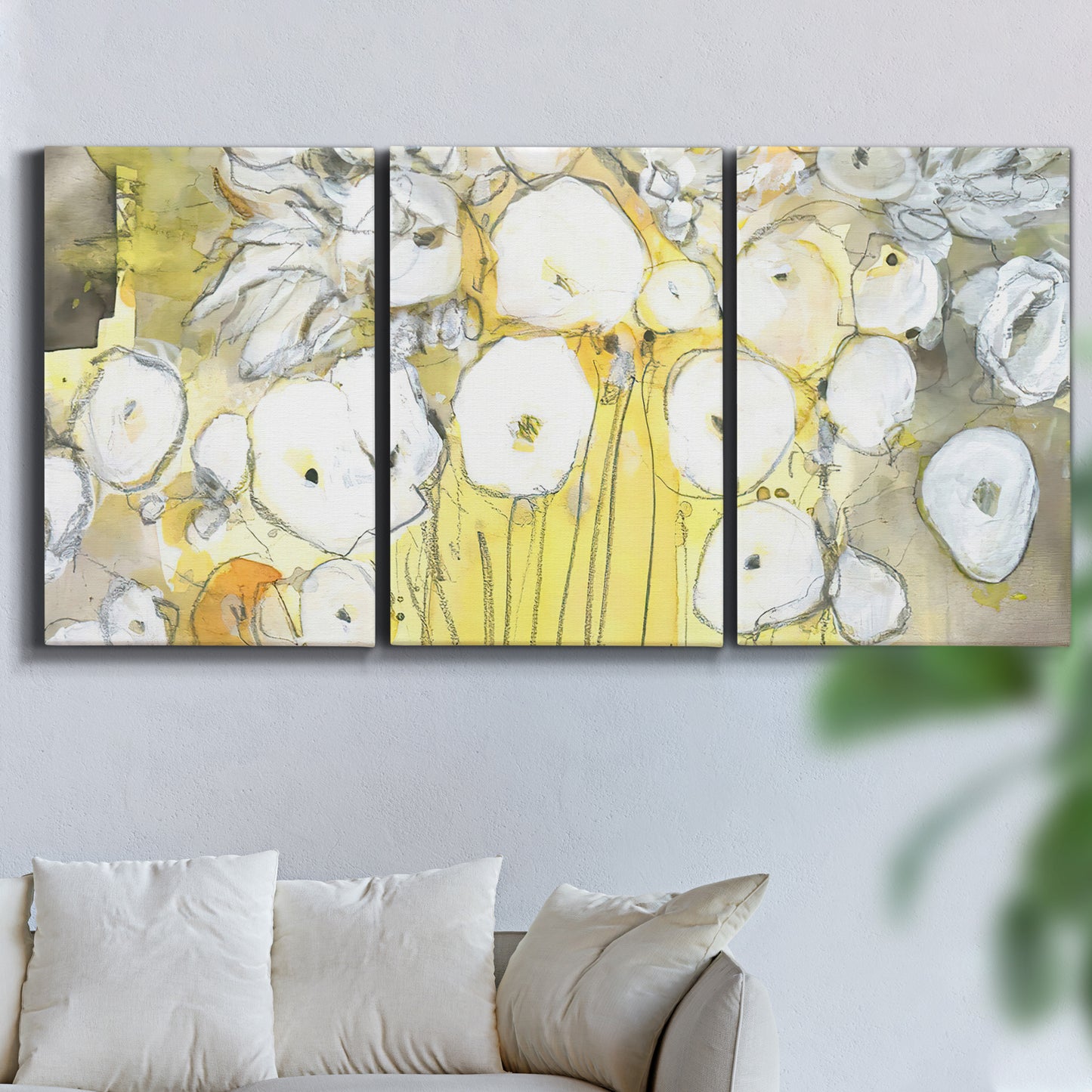 Three-panel canvas wall art featuring vintage inspired floral abstraction, displayed in a living room above a sofa.