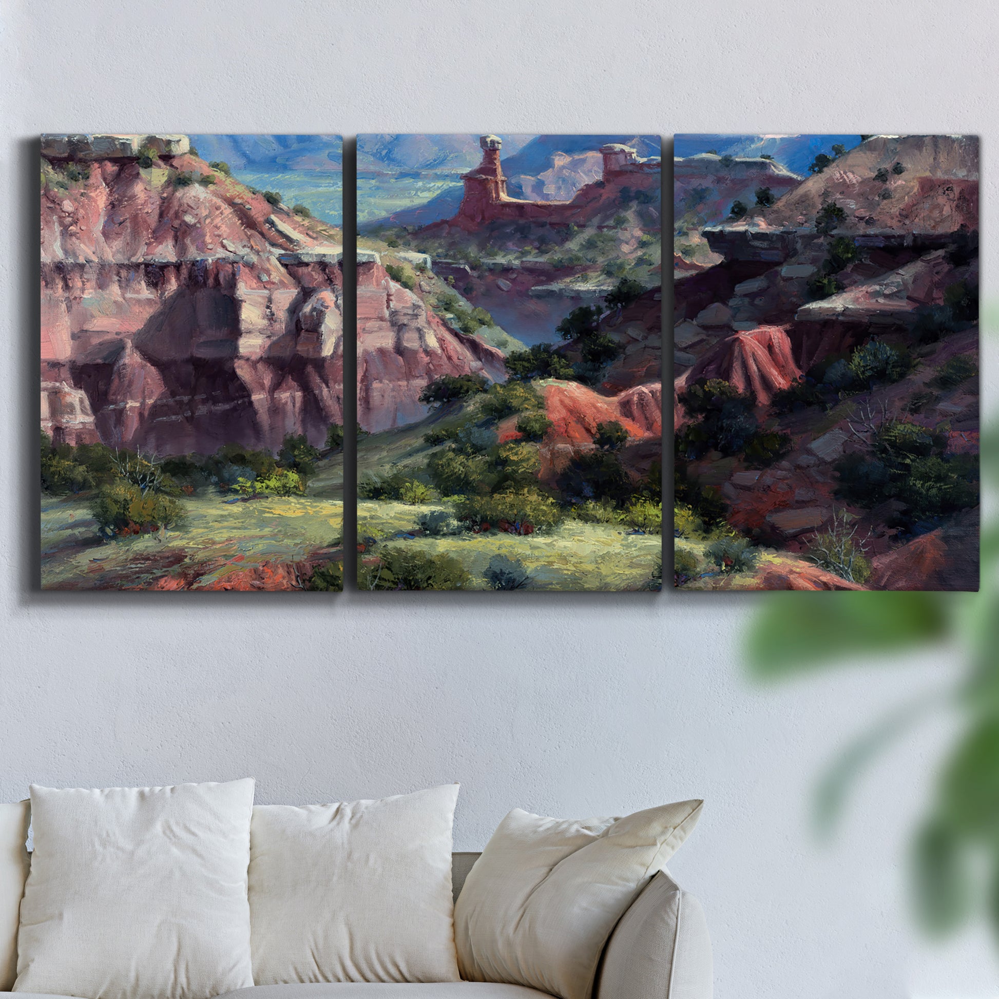 Three-panel canvas wall art featuring classic canyon landscape scene, displayed in a living room above a sofa.