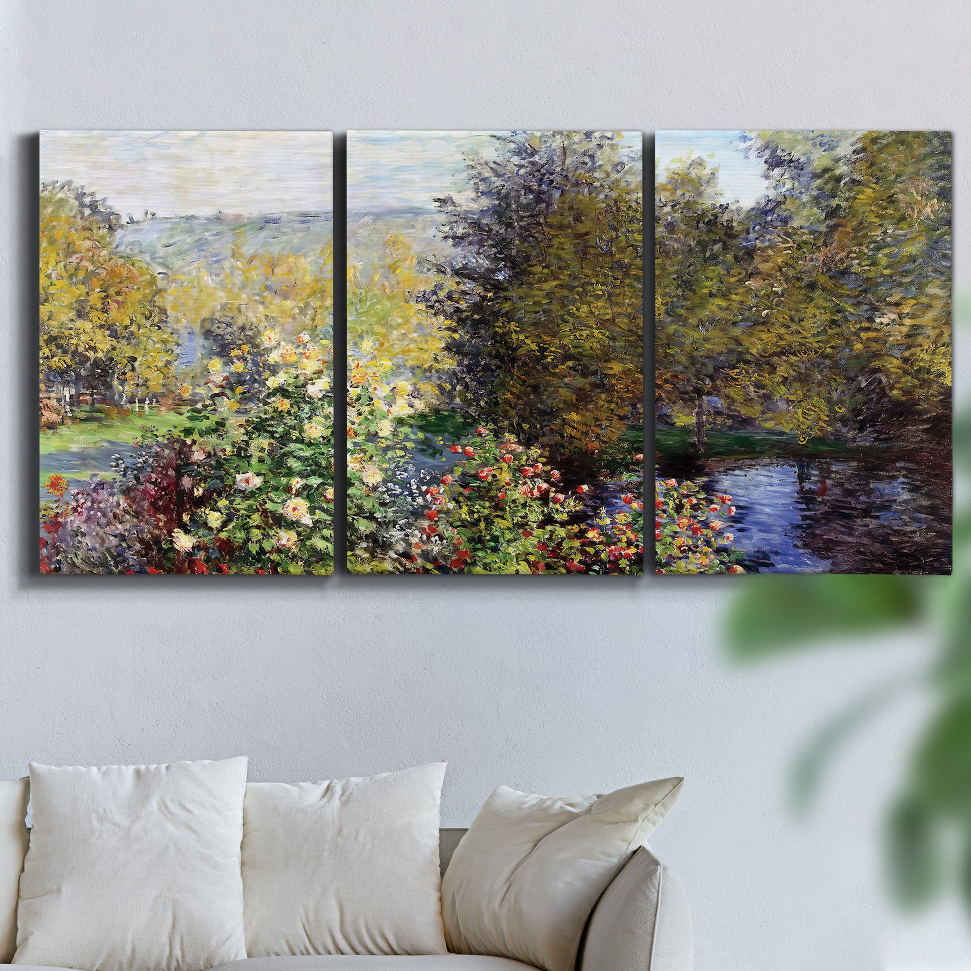 Three-panel canvas wall art featuring garden corner with flowering trees, displayed in a living room above a sofa.