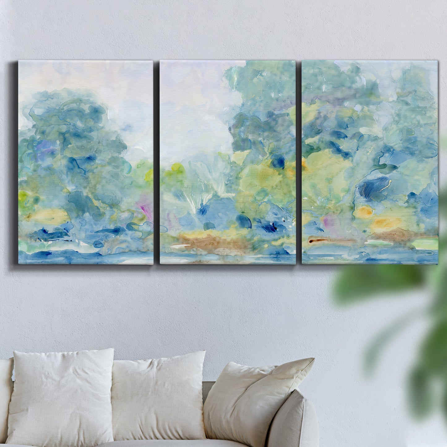 Three-panel canvas wall art featuring quiet abstract morning landscape, displayed in a living room above a sofa.