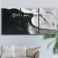 Three-panel canvas wall art featuring black and white crashing ocean waves, displayed in a living room above a sofa.