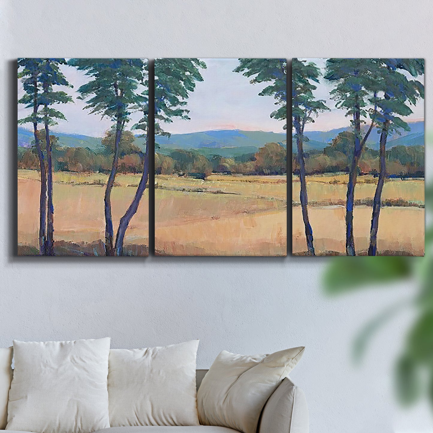 Three-panel canvas wall art featuring quiet morning landscape with trees, displayed in a living room above a sofa.