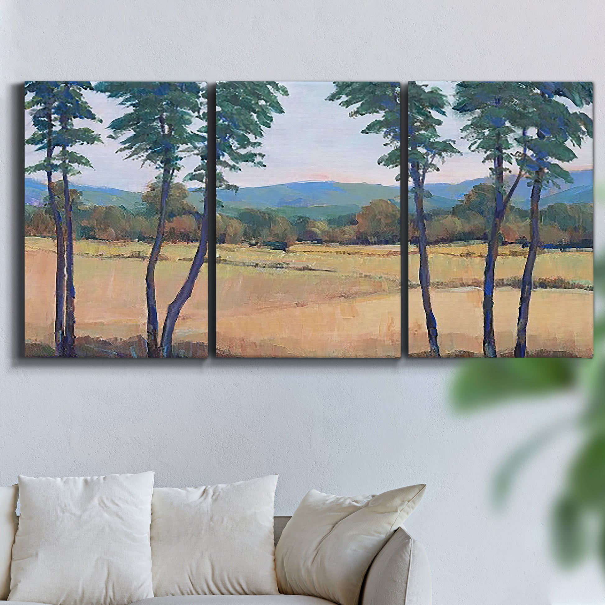 Three-panel canvas wall art featuring quiet morning landscape with trees, displayed in a living room above a sofa.